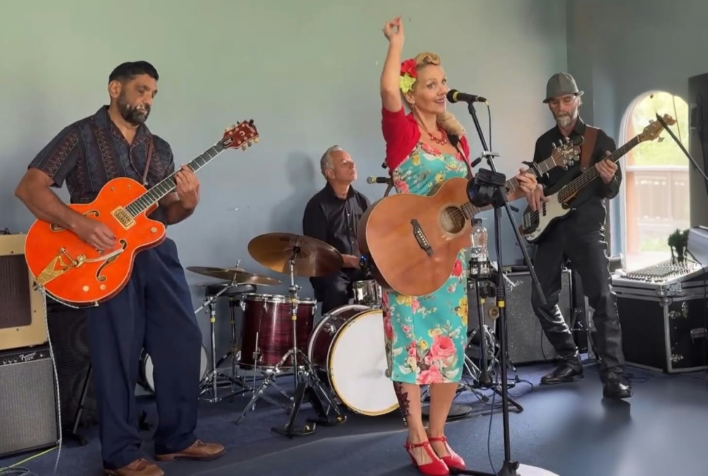 Lorna-Jane raising a hand while performing with the band