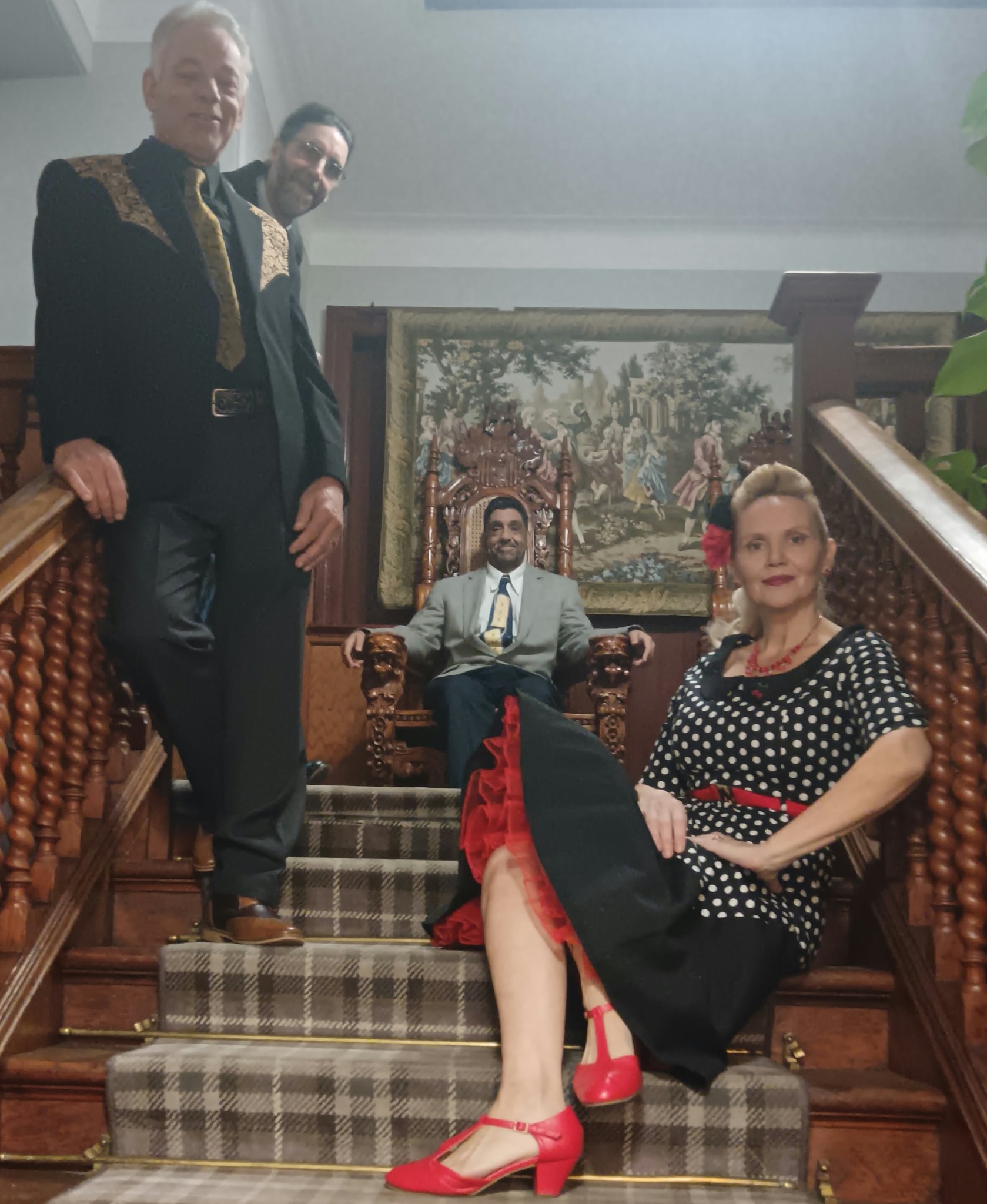 The band posing together on a staircase, with Lorna-Jane seated at the front