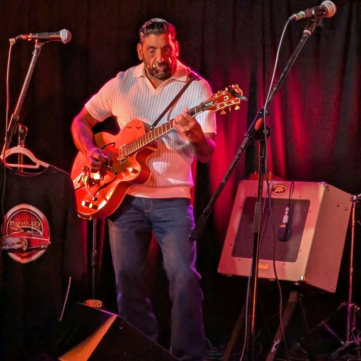 Chris performing with his guitar