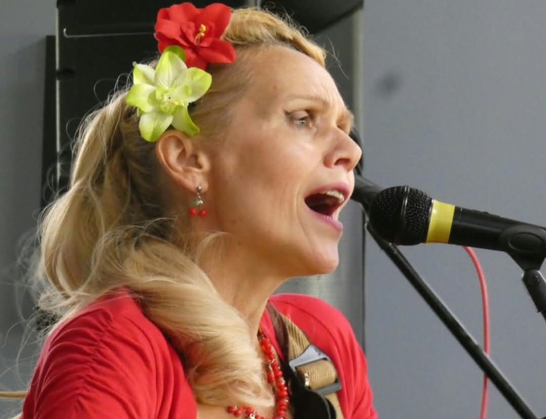 Lorna-Jane singing into a microphone